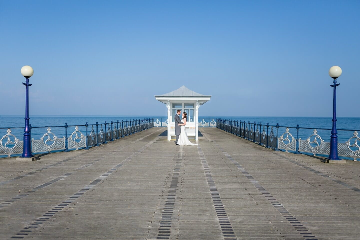 Wedding couple at the end of Swanage Pier, an image taken by Somerset Photographer Victoria Welton