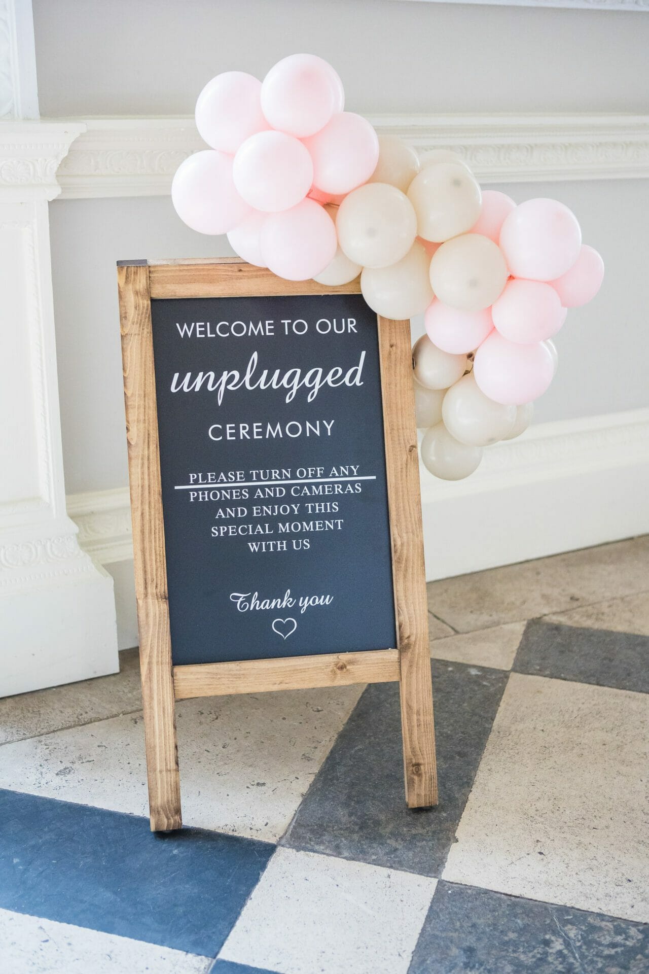 A sign used at a wedding for an unplugged ceremony showing you can enjoy your wedding without devices. Shown at Crowcombe Court Wedding venue and taken by Somerset Wedding Photographer, Victoria Welton