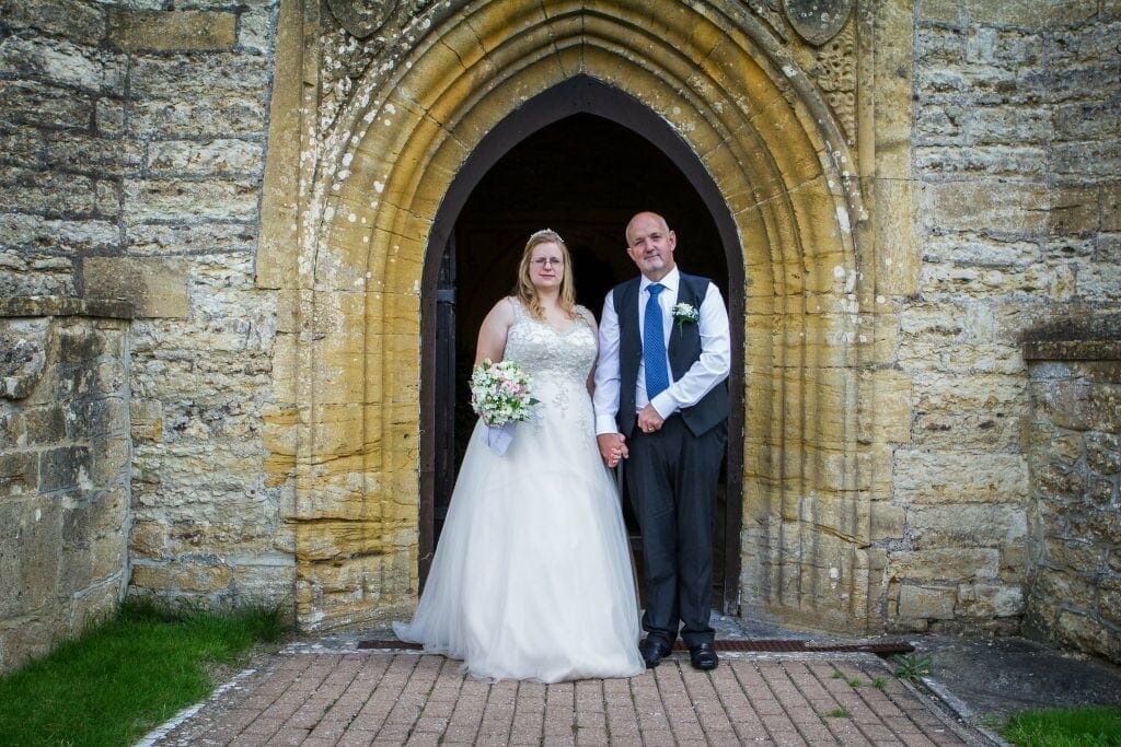 The bride and groom at the doorway of Abbey Manor in Yeovil, Somerset.