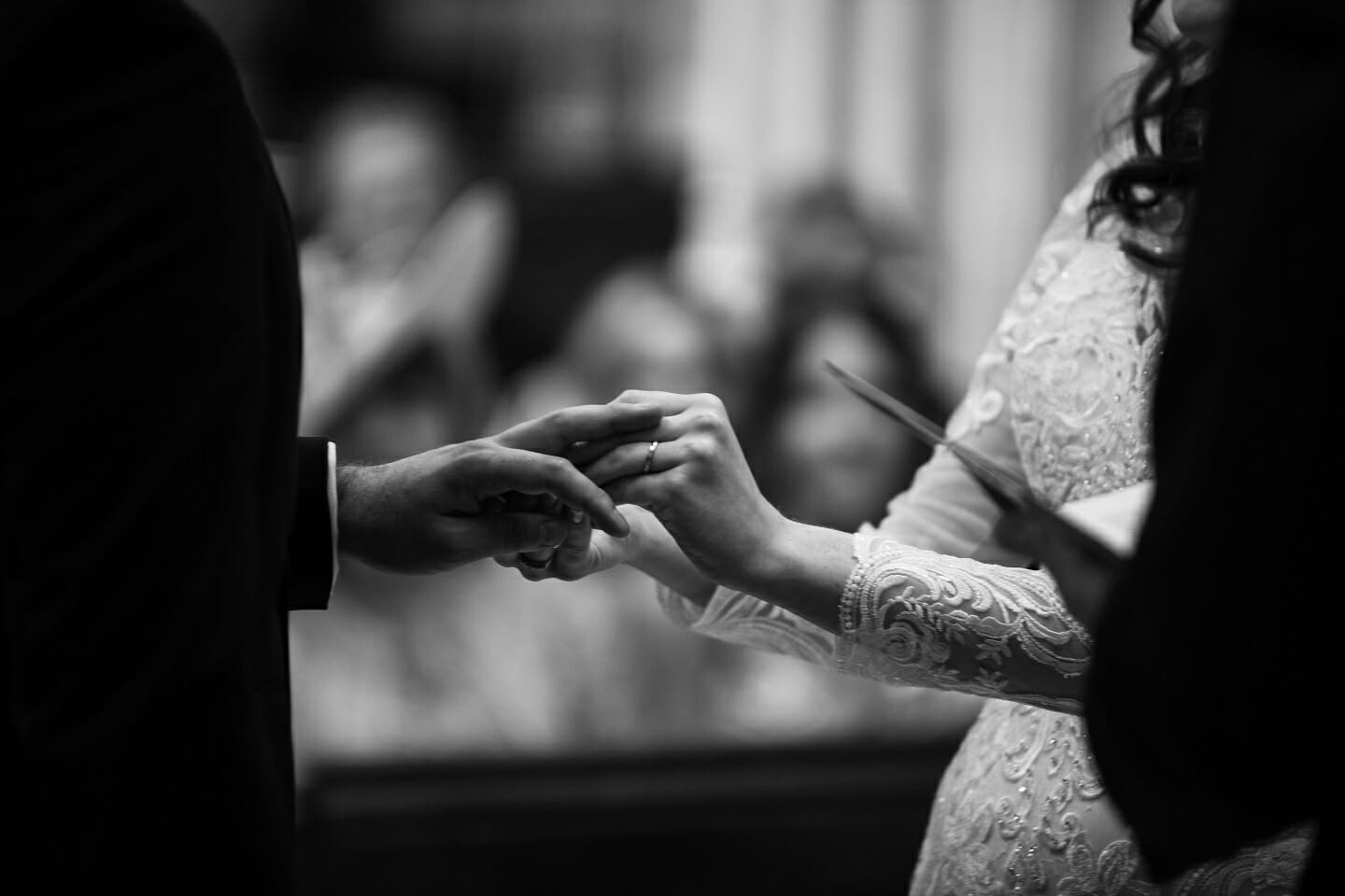 What Age Do Men Get Married - a black and white photo of a bride putting a ring on her Groom's finger